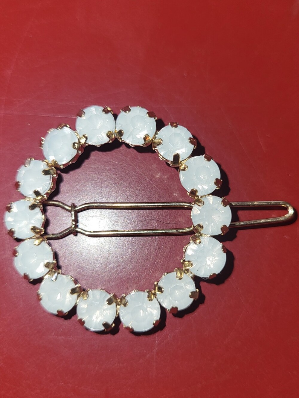 Gold tone and white round hair clip